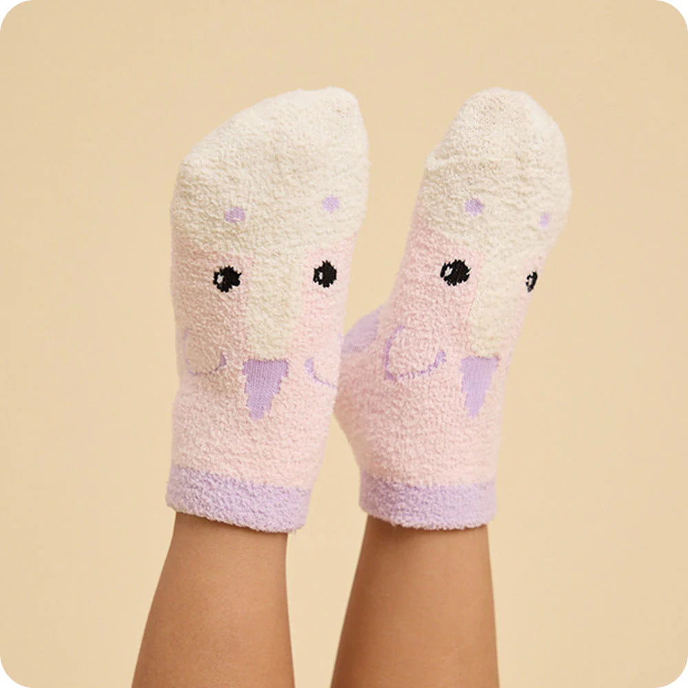 Pair of soft, plush socks with a cartoon face design on a beige background